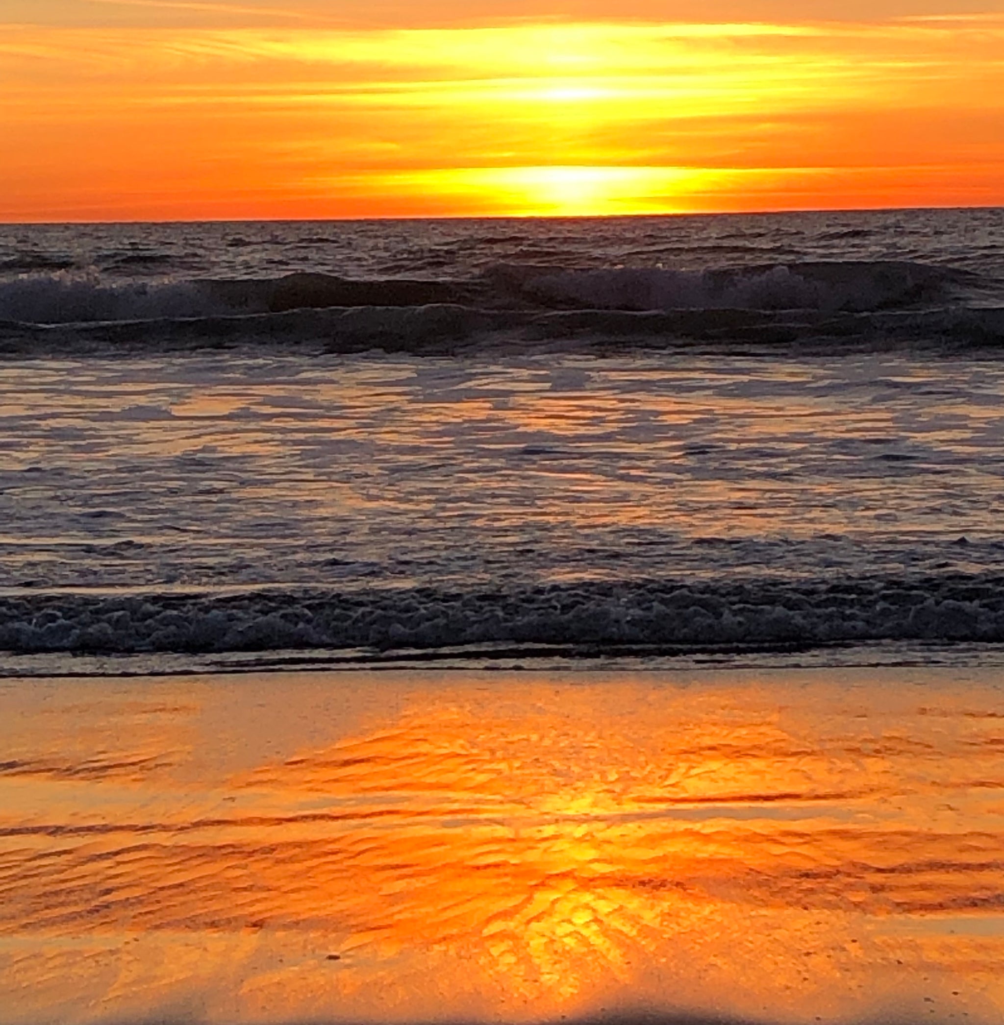 Sunset at a CA Beach photo where the Ocean meets the Land